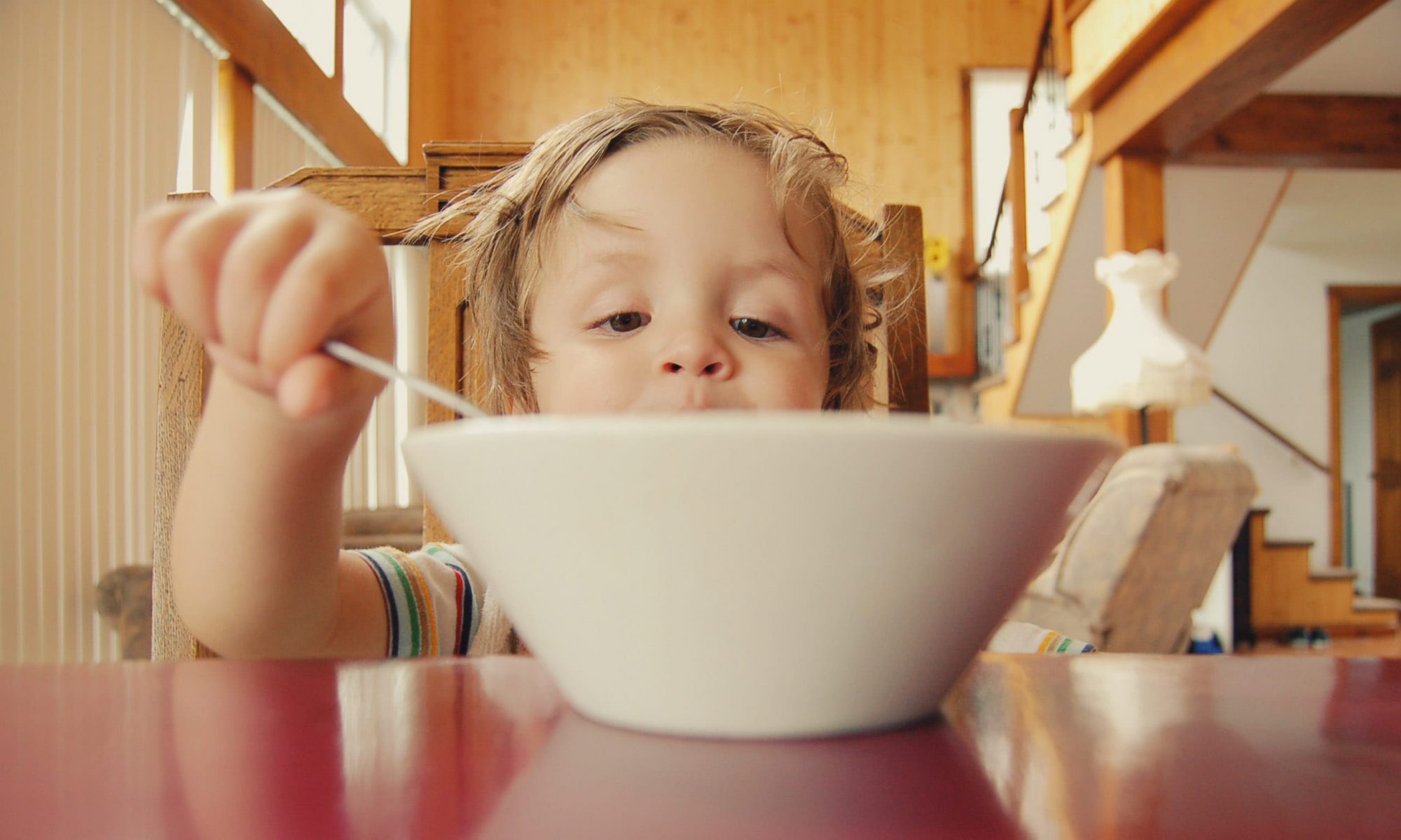 Boy eating cereal at home